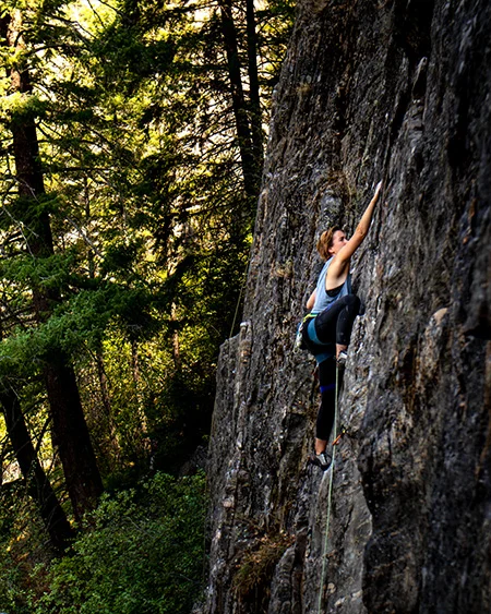 A climber roping up at the base.