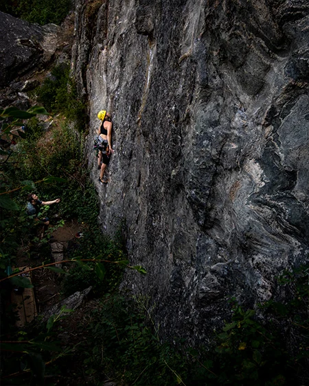 A climber working a route in the evening light.